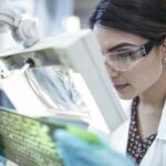 Female_technician_examining_motherboard