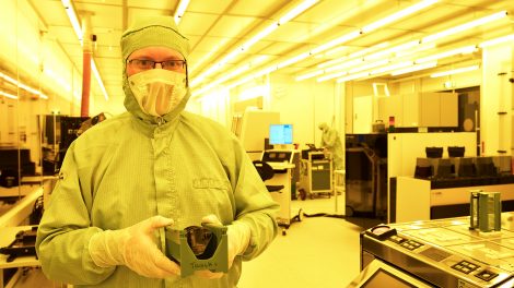Picture of Luc Augustin with wafer containing photonic chips