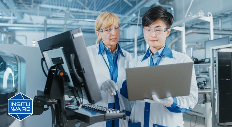 Two employees using machines in factory